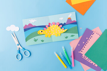 dinosaur paper craft handmade greeting card school project creative hobby diy activity childhood education art supply preschool lesson plan home decor colorful stegosaurus volcano illustration © Elena