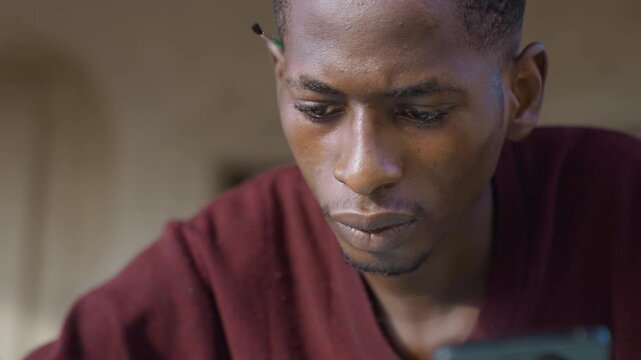 Focused man referencing phone sketch, designer comparing screen to paper frames portray roles as researcher, planner, product designer, layout artist, visual student closeup hands, intentional pencil