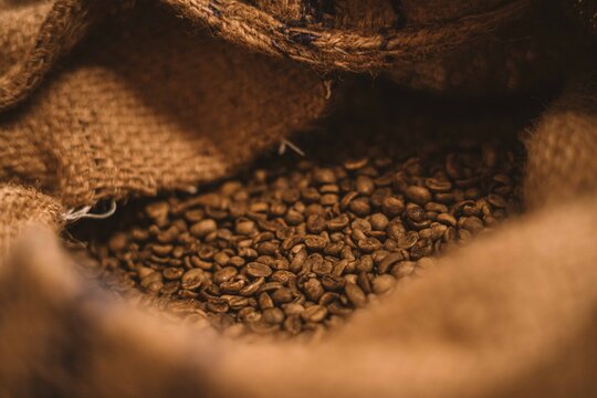 Dark Roast coffee and a scoop on a rustic background on burlap