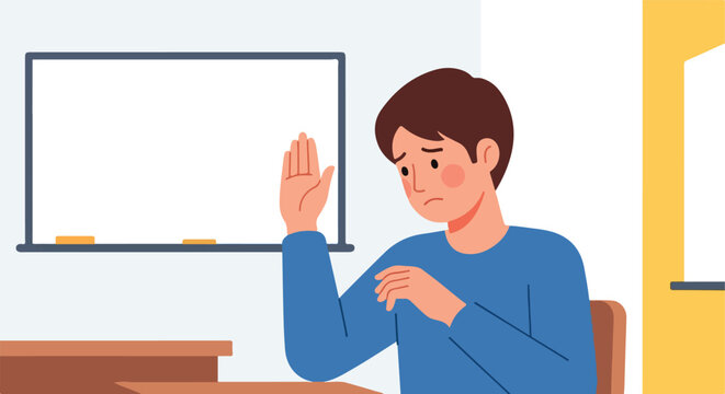 A sad young student sitting at a desk and raising his hand in a classroom