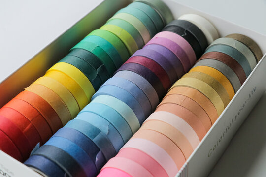 Colorful washi tape in white box. Art and crafts creative journal crafts supplies to decorate notebook and create fun projects. 