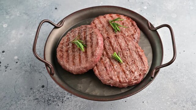 Grilling meat patties on a stovetop for a quick and easy meal in a home kitchen setting