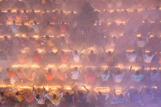 Baradi, Bangladesh - 09 November 2024: View of devotees gathered at Sri Sri Loknath Bramhachari Shomadhi Mondir with lit candles and incense smoke during the Rakher Upabash festival.