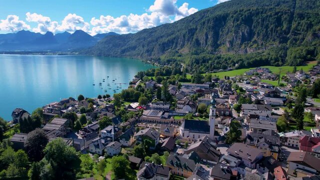 St. Gilgen Austria Drone Video, Aerial View of Idyllic Alpine Village with White Church Tower, Scenic Wolfgangsee Lake and High Mountains Backdrop, Traditional Austrian Architecture Travel 4K
