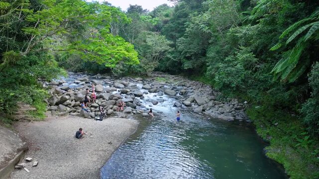 Aerial footage of peopl enjoying the Mayemes River, El Yunque, PR