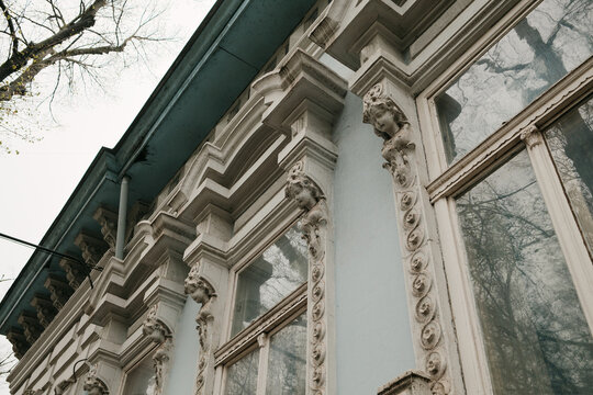 Decorative facade details with sculptural ornaments on historic building in Senta Serbia, highlighting classical design and architectural craftsmanship.