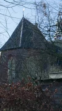 Medieval oude kerk in oosterbeek revealing itself behind trees