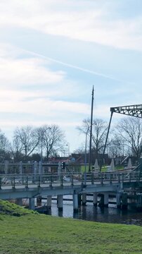 Dutch bascule bridge opening to let a boat pass through a canal