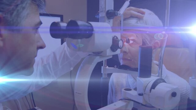 Animation of light trails over diverse doctor and patient using slit lamp