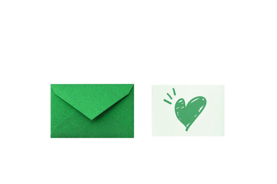 Seen from above: a closed green glitter envelope next to a message card with a hand-drawn green heart	