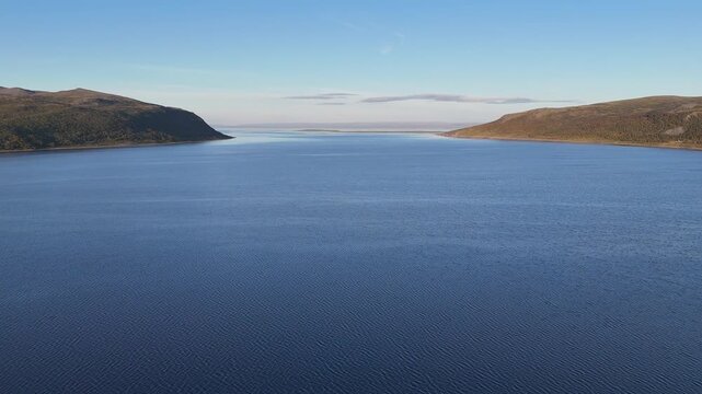 Aerial drone flying over sea away from Olderfjord Norway