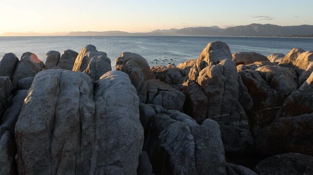 Rocky coastline, DeKelders,  South  Africa, overlooking Walker Bay Nature Reserve and Klein Mountains