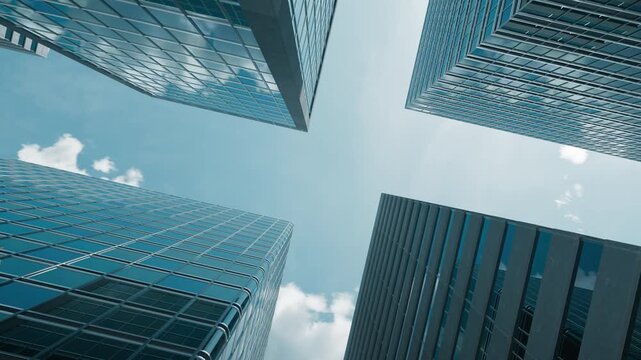 Glass corporate skyscrapers against a fast day-to-night sky in a time-lapse animation. Corporate timelines, urban economic cycles, and financial district developments.