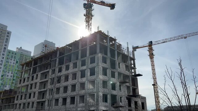 Process of building a multi-storey residential building. Tower cranes