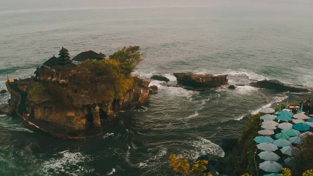 Breathtaking aerial view of of Tanah Lot Temple. Tanah Lot is a rock formation off the Indonesian island of Bali. It's home to the pilgrimage temple Pura Tanah Lot, a popular tourist and cultural icon