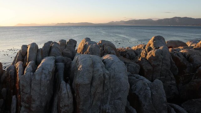 Rocky coastline, DeKelders,  South  Africa, overlooking Walker Bay Nature Reserve and Klein Mountains