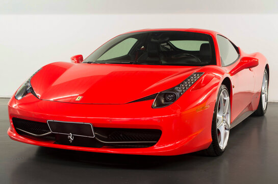 Red Ferrari 458 Italia front three quarters view, Luxury supercar in studio
