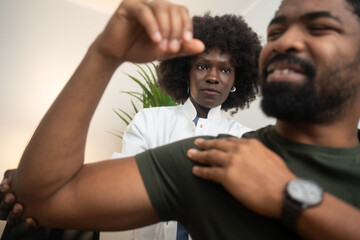 Obraz premium Physical therapists are checking patients shoulder at the clinic office room.