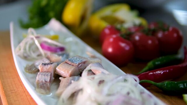Close-up of a lightly salted herring fillet on a white plate. Healthy, natural food. High quality 4k footage
