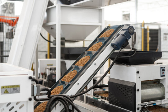 Industrial automated conveyor system for granular material sorting and handling in manufacturing facility