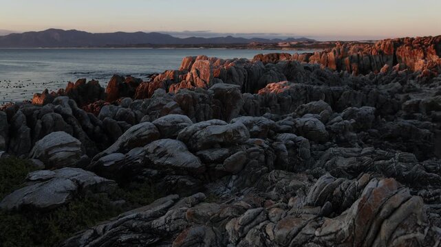 Rocky coastline, DeKelders,  South  Africa, overlooking Walker Bay Nature Reserve and Klein Mountains