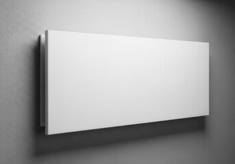 Fototapeta premium A minimalist white rectangular heater mounted on a smooth grey wall for modern home interiors.