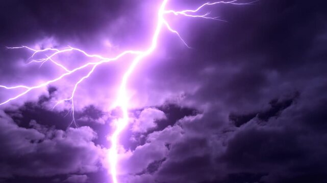 Slow motion static shot of lightning bolt striking through storm clouds illuminating night sky with purple glow and branching forks during thunderstorm