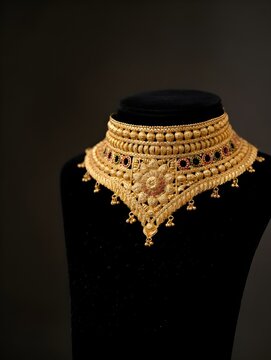 Gold necklace on black lace display stand