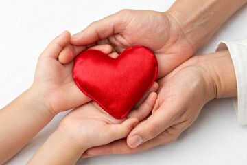 Obraz premium child hands holding heart, with fathers hands, on father day