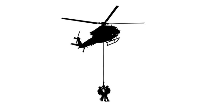 Silhouette of a helicopter performing a rescue operation with two people being hoisted up.