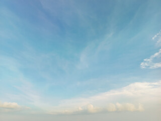 Fototapeta premium Expansive Blue Sky with Soft White Clouds and Gentle Atmospheric Background for Nature Concepts