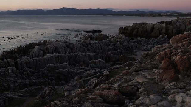 Rocky coastline, DeKelders,  South  Africa, overlooking Walker Bay Nature Reserve and Klein Mountains