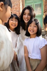 Obraz premium Woman interacting happily with group of girls on street