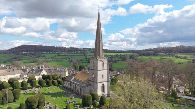 An aerial view of the church and spire in a Cotswolds hilltop town