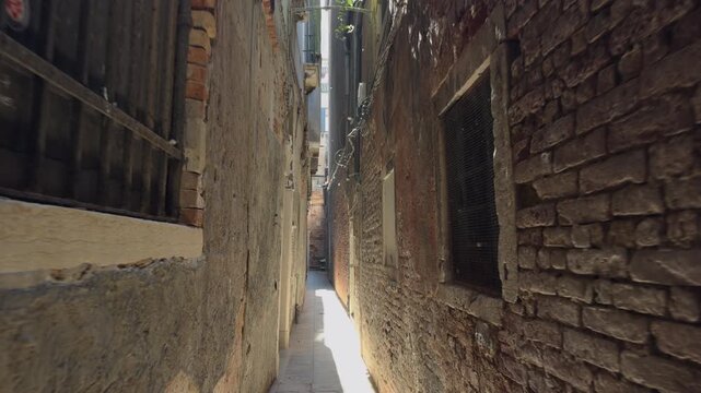 Walking through narrow stone alley in historic city