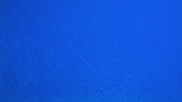 Close up of blue ice cubes underwater with oxygen bubbles, frost patterns, and soft light reflections. Concepts for beauty advertising, menu designs for bars and restaurants, cryotherapy.