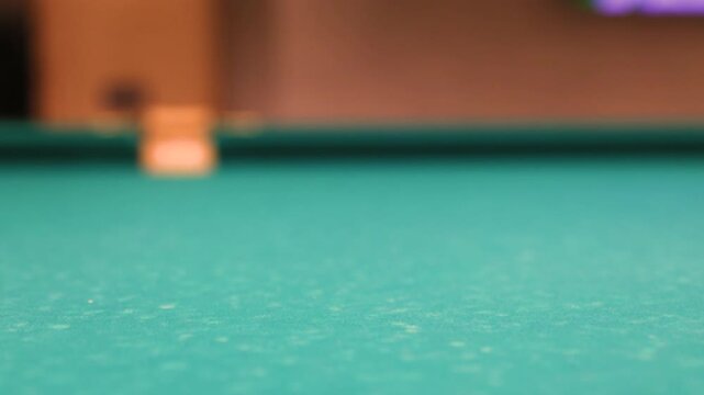 Two small white billiard balls on green felt close up view of billiard table