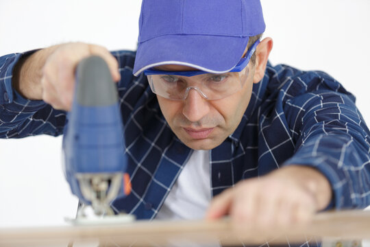 close up man cuts a wood