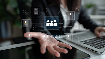 Fototapeta premium A business professional interacts with digital data representing team connections and analytics in a modern office, emphasizing technology and teamwork for better performance. Ledger