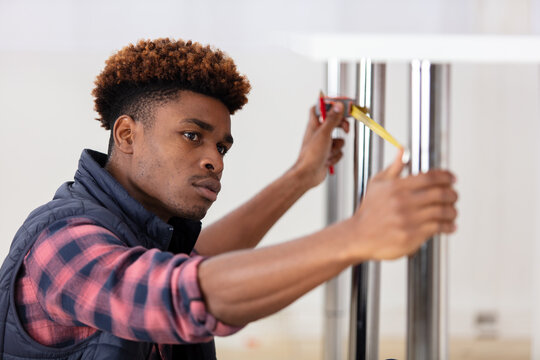 contractor young repairman assembling furniture