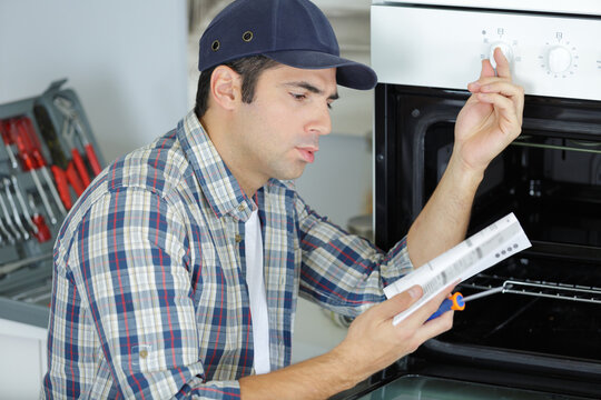 a man reading oven instructions