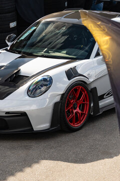 White Porsche 911 GT2 RS front end high angle view, Luxury super car external shot outdoors