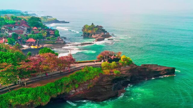 Breathtaking aerial view of of Tanah Lot Temple. Tanah Lot is a rock formation off the Indonesian island of Bali. It's home to the pilgrimage temple Pura Tanah Lot, a popular tourist and cultural icon