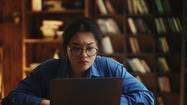 Young Korean woman in eyeglasses having problems with laptop, hacking attack