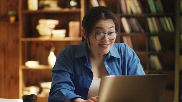 Young Korean woman freelancer reading good news email, won a business grant