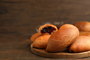 Fototapeta premium Yummy baked patties on wooden table, closeup. Space for text