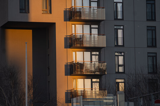 Modern apartment building balconies with warm sunlight