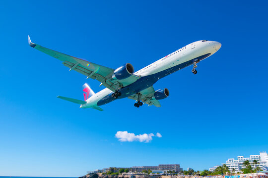 Delta Air Lines Boeing 757-200 N6701 flying over Maho Beach before landing on Princess Juliana International Airport SXM on Sint Maarten, Dutch Caribbean. 