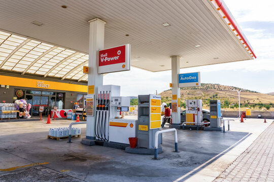 Nevsehir, Turkey - September 18, 2025: Shell V-Power fuel station with AutoGas pumps and convenience store, surrounded by hills and clear blue sky in a rural setting