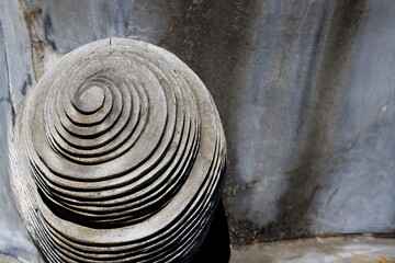 Naklejka premium Abstract geometric composition of carved stone with concentric circular layers. Minimal design with natural texture, light and shadow in neutral grey tones.